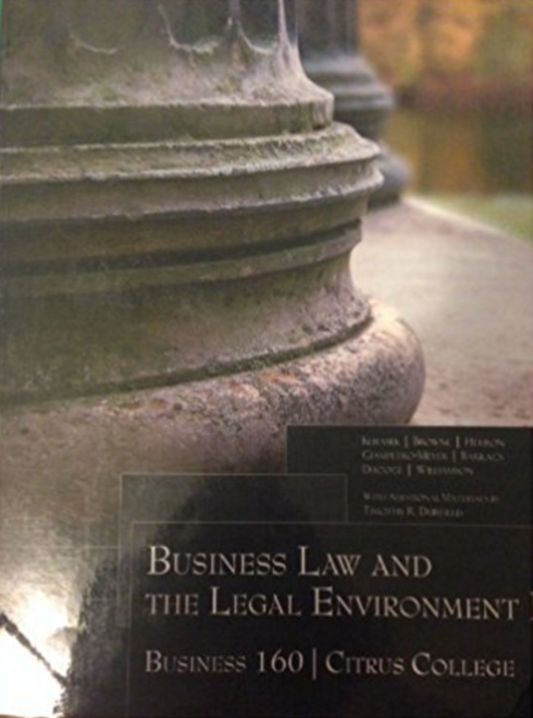 Open business law textbook displaying chapters on contracts, corporate law, and ethics, with a pen and laptop nearby, symbolizing study of legal environment in business